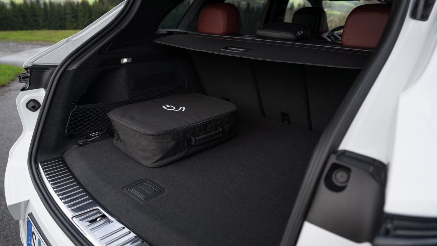 Open boot of the white Porsche Cayenne E-Hybrid with the charging cable bag