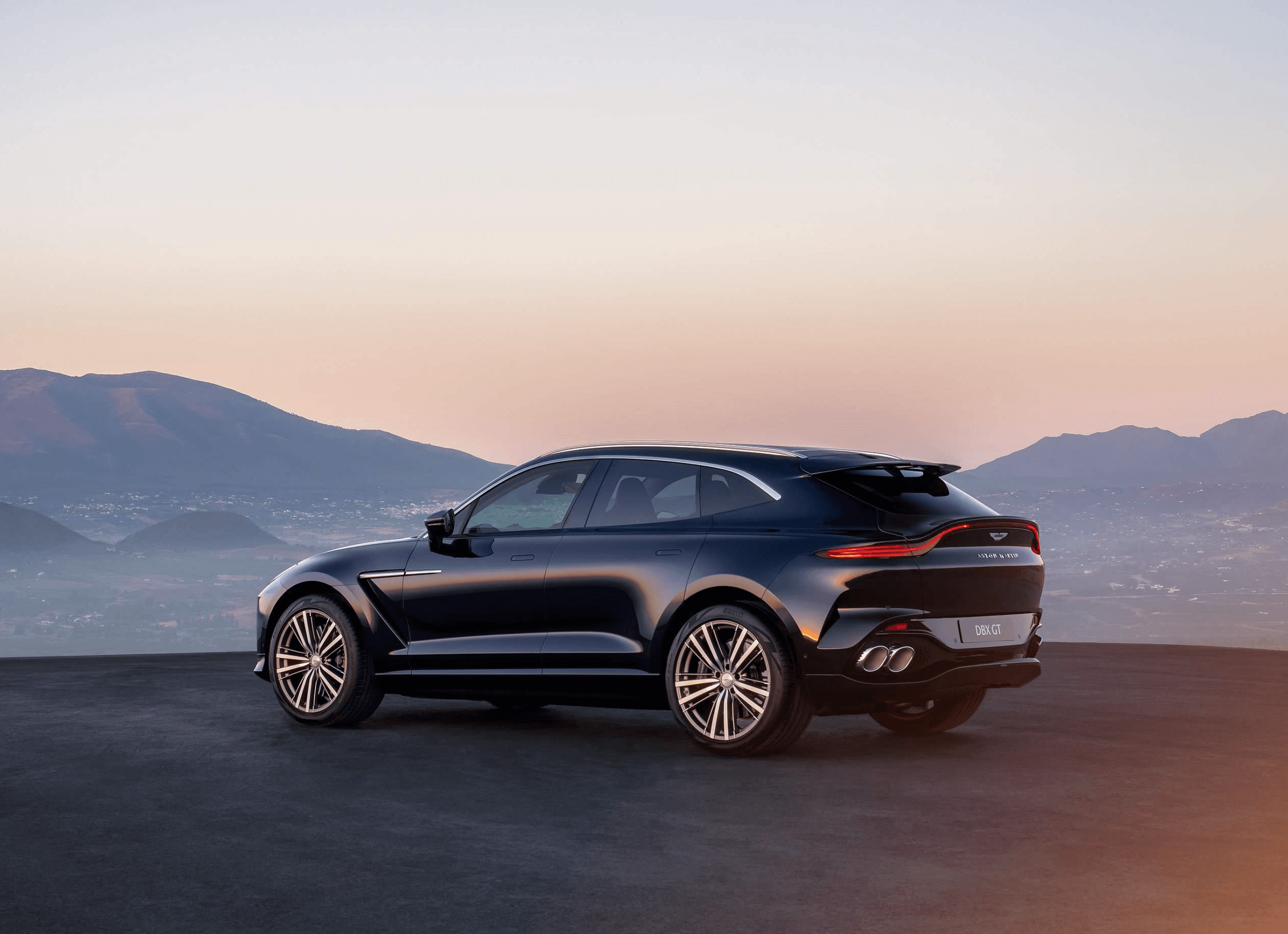 v8 suv on mountain road at dusk